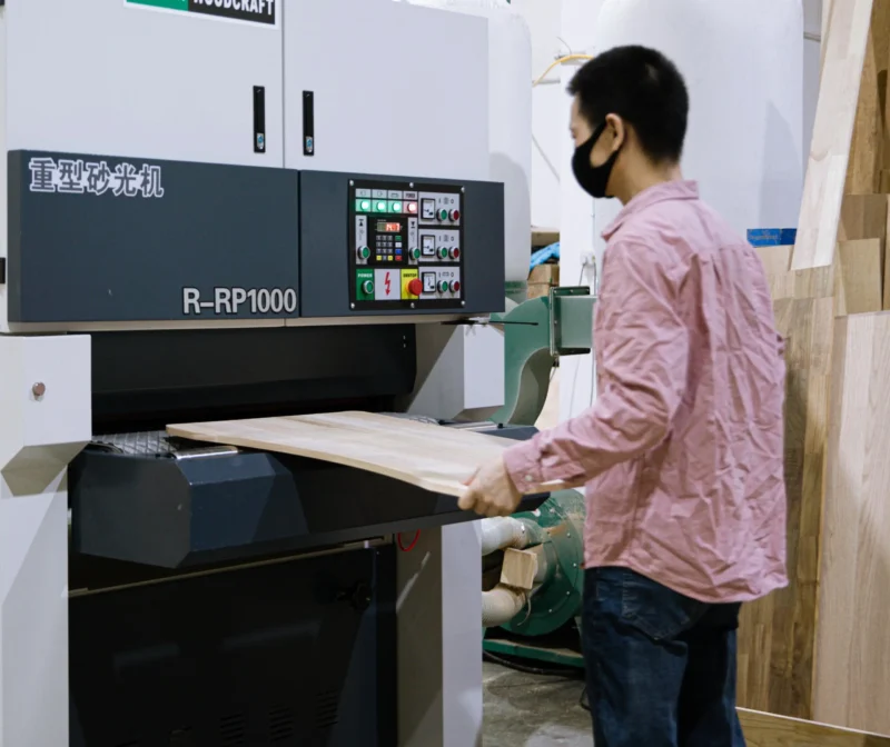 craftsman cutting wood plank